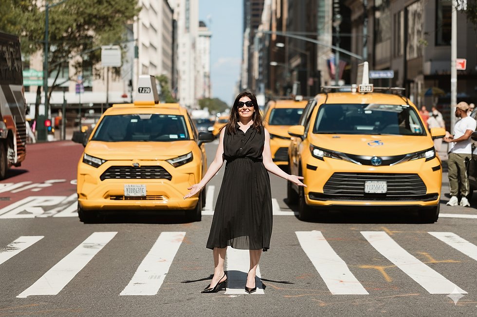 Michal Globen on a Manhattan crosswalk among yellow taxis